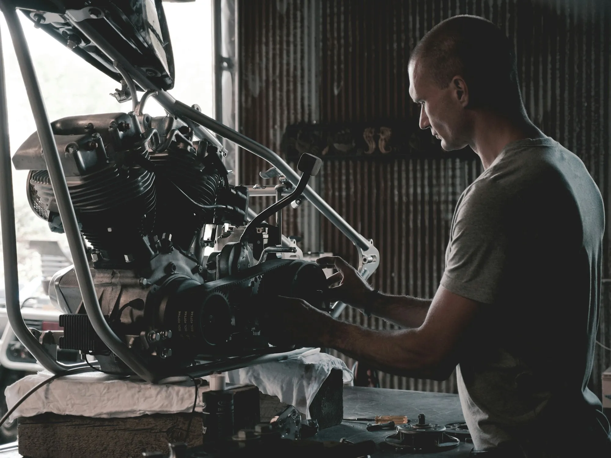Mechanic lifting a cylinder head from an engine block