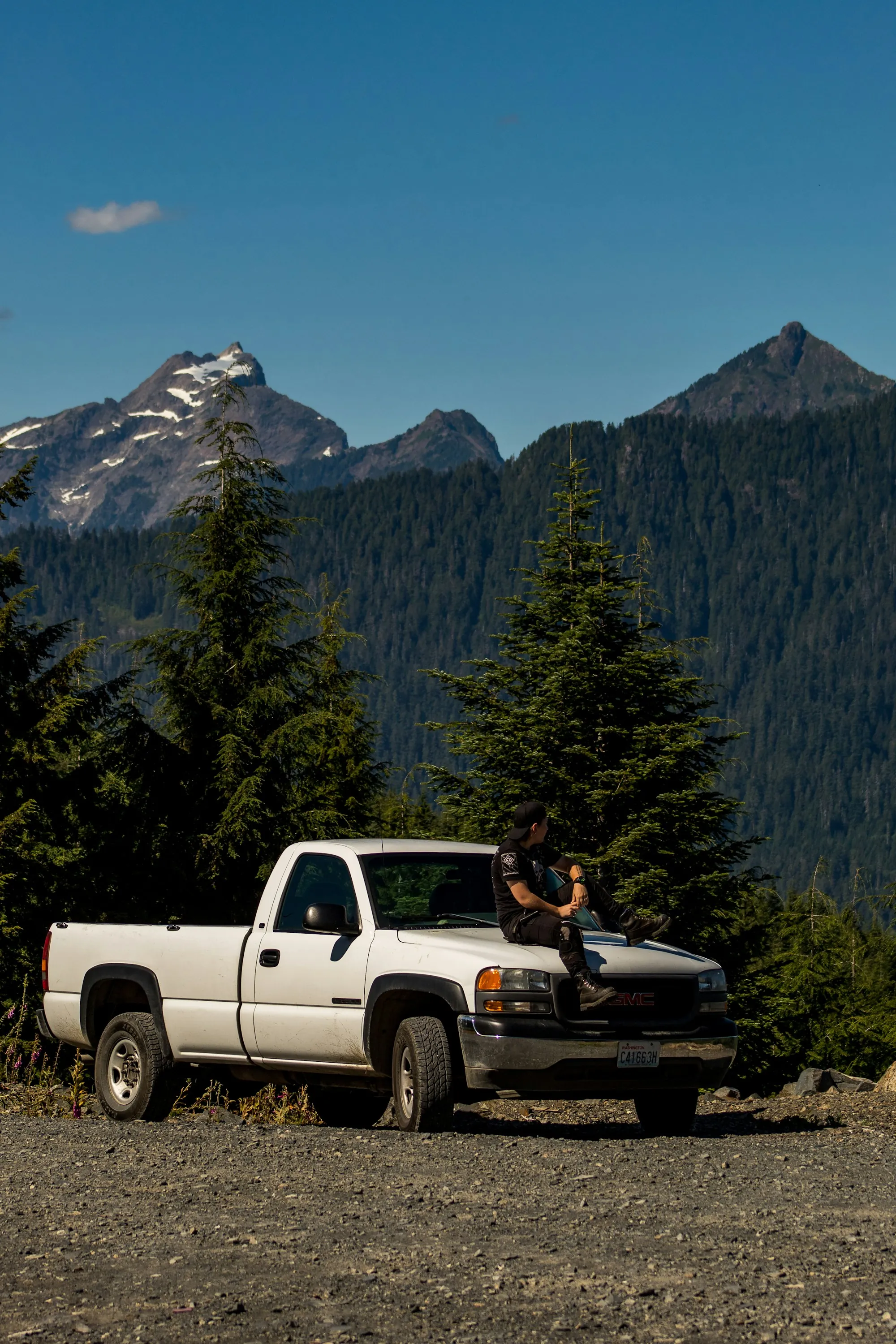 White pickup truck parked on a mountain road