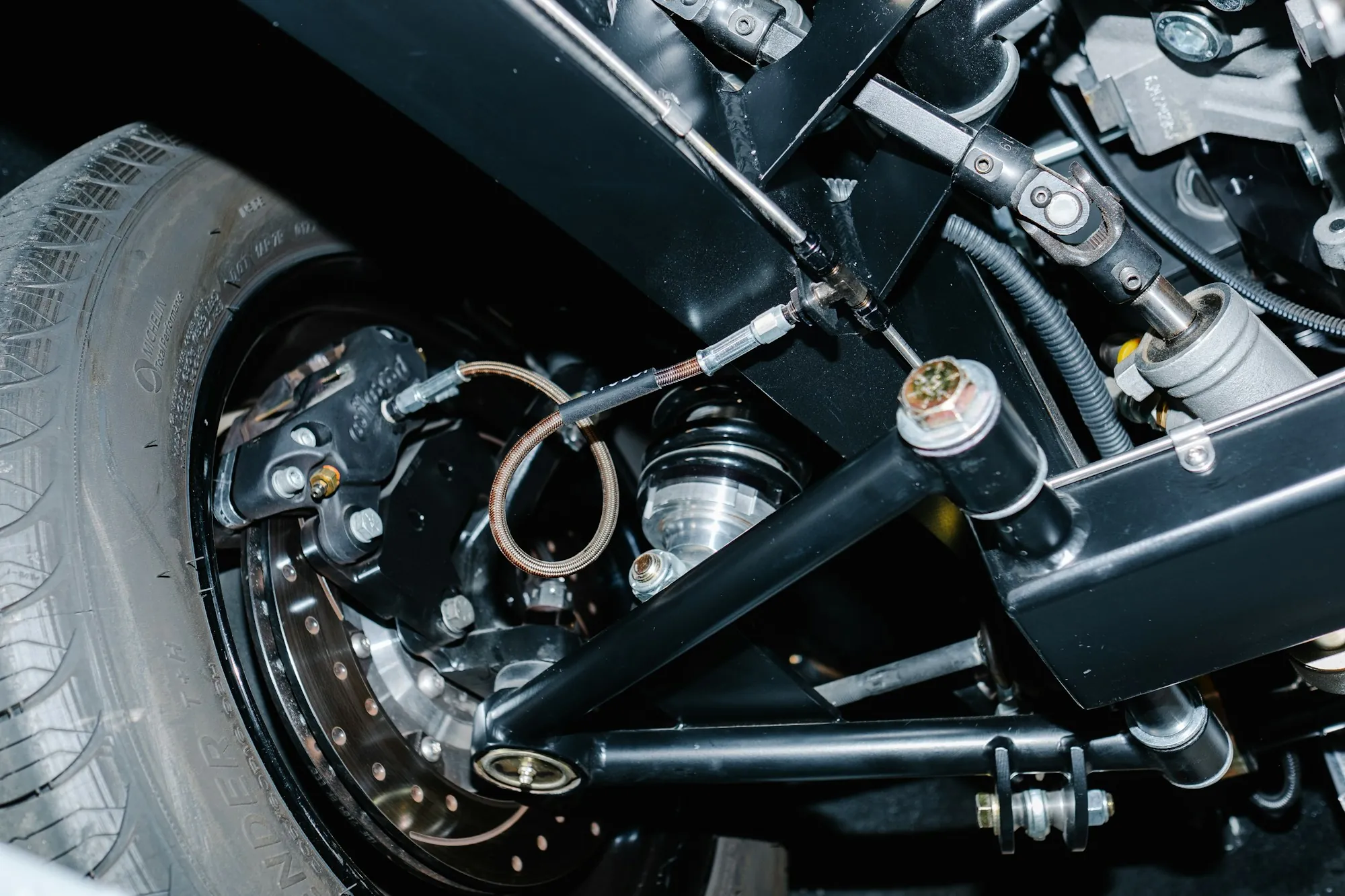 Suspension arm and brake assembly under a car